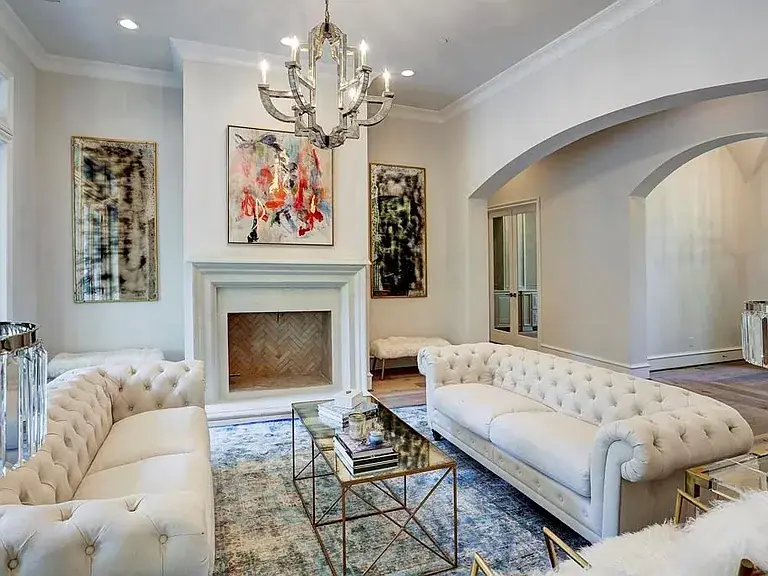 Living room with tufted sofas and chandelier at 12 Valley Forge Dr